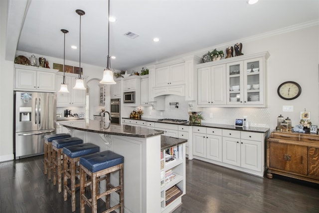 34119 Mill Creek Way, Pinehurst, TX 77362 - kitchen featuring crown molding, appliances with stainless steel finishes, white cabinets, and visible vents