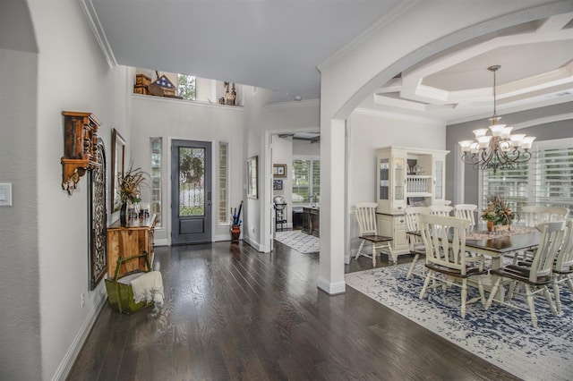 34119 Mill Creek Way, Pinehurst, TX 77362 - foyer with ornamental molding, wood finished floors, baseboards, arched walkways, and a notable chandelier