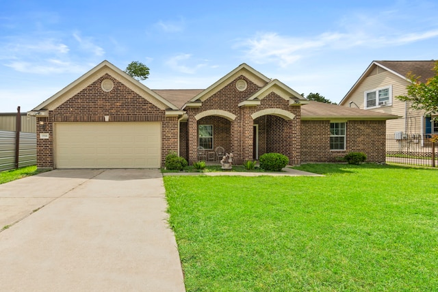 ranch-style home with a front yard, brick siding, fence, concrete driveway, and an attached garage