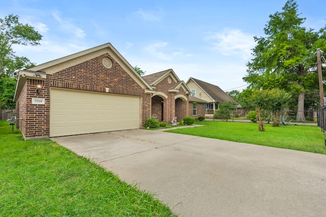 traditional-style house featuring an attached garage, concrete driveway, a front yard, and brick siding