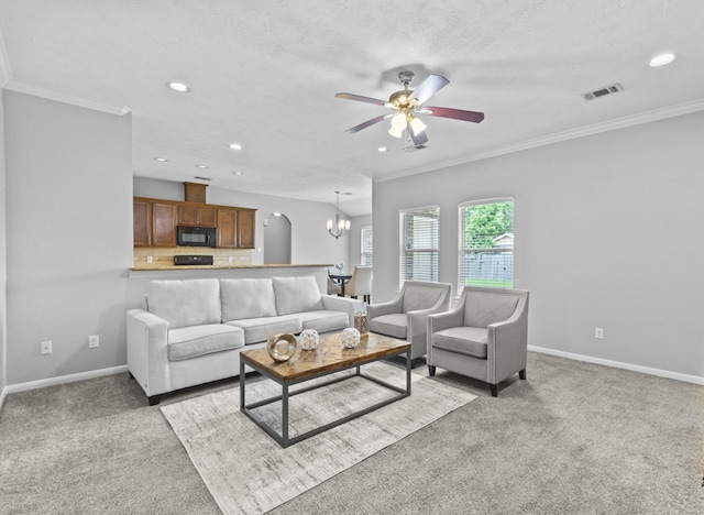 living room featuring baseboards, ornamental molding, light carpet, and visible vents