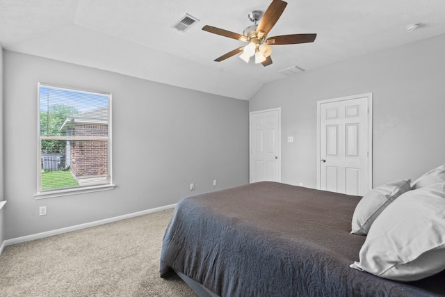 carpeted bedroom with baseboards, visible vents, ceiling fan, and lofted ceiling