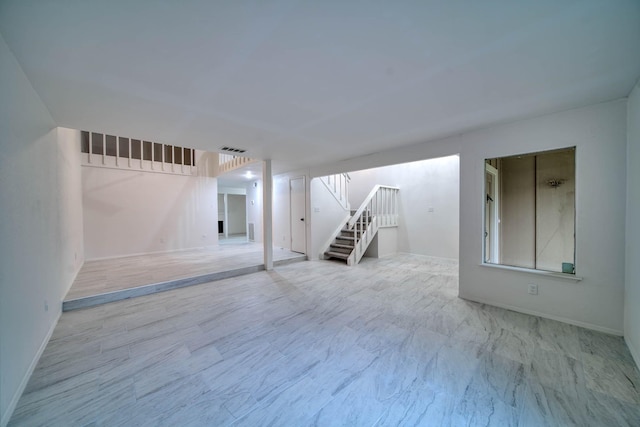 interior space with stairs, baseboards, and visible vents