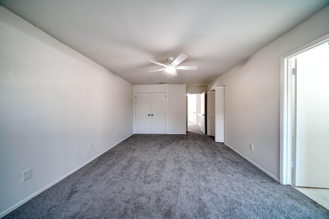 unfurnished bedroom featuring carpet floors, baseboards, and multiple closets