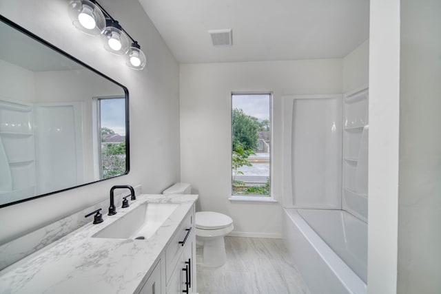bathroom featuring vanity, toilet, baseboards, shower / bath combination, and visible vents