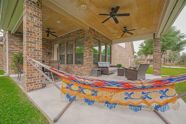 view of patio / terrace featuring fence, ceiling fan, and an outdoor living space