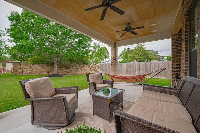 view of patio / terrace with an outdoor living space, a fenced backyard, and ceiling fan