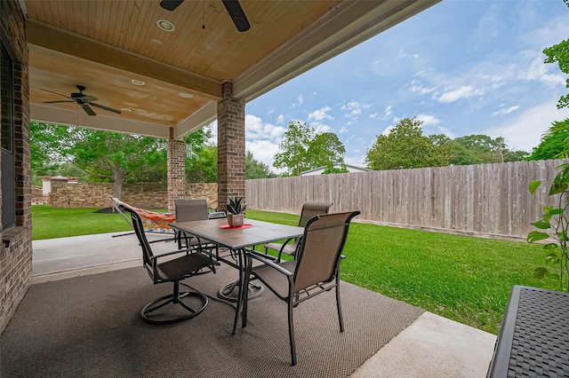 view of patio featuring a fenced backyard, a ceiling fan, and outdoor dining area