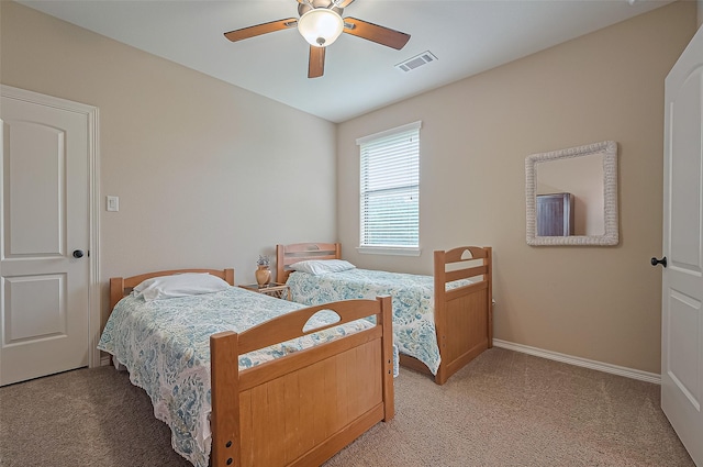 bedroom with light colored carpet, baseboards, ceiling fan, and visible vents