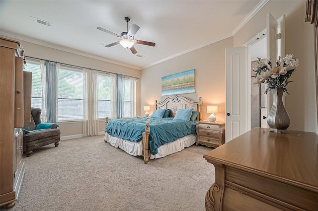carpeted bedroom featuring baseboards, ornamental molding, ceiling fan, and visible vents