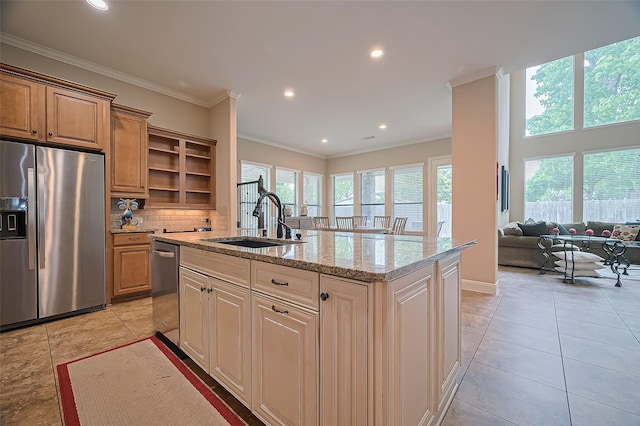 kitchen with open shelves, an island with sink, light stone counters, a sink, and appliances with stainless steel finishes