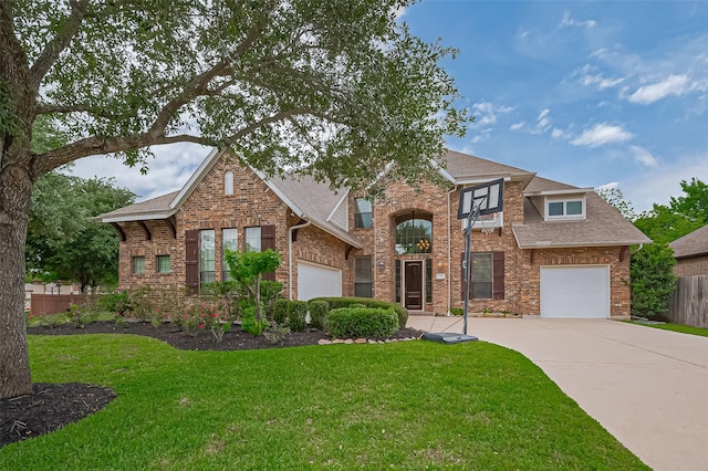 traditional-style house featuring brick siding, driveway, and a front yard