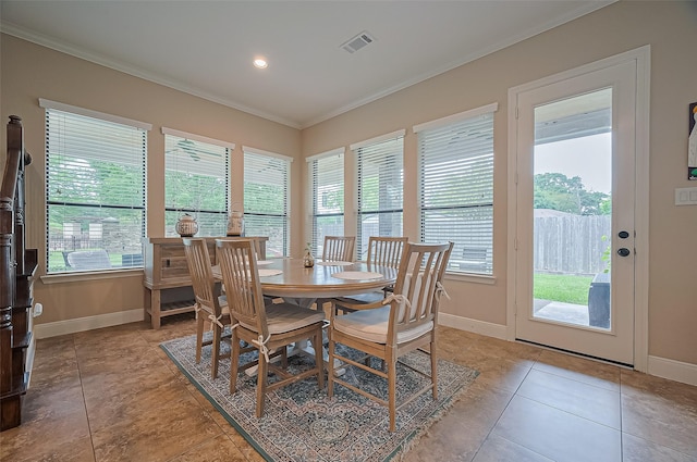 dining area with a healthy amount of sunlight, baseboards, ornamental molding, and visible vents