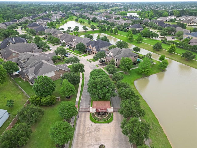 birds eye view of property with a water view and a residential view