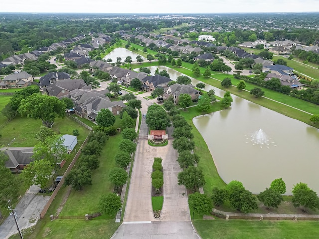 birds eye view of property with a water view and a residential view