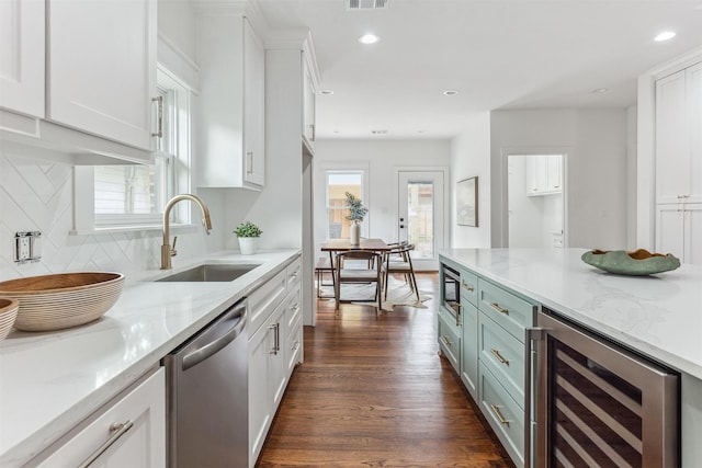 1026 Fugate St, Houston, TX 77009 - kitchen with wine cooler, dishwasher, a sink, white cabinetry, and recessed lighting