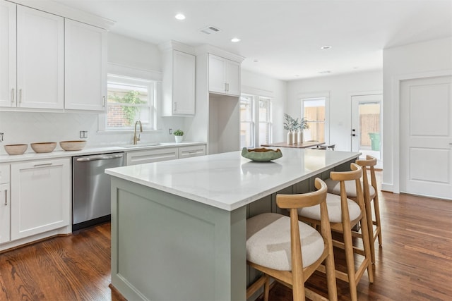 1026 Fugate St, Houston, TX 77009 - kitchen with dishwasher, dark wood-style flooring, a kitchen island, white cabinetry, and recessed lighting
