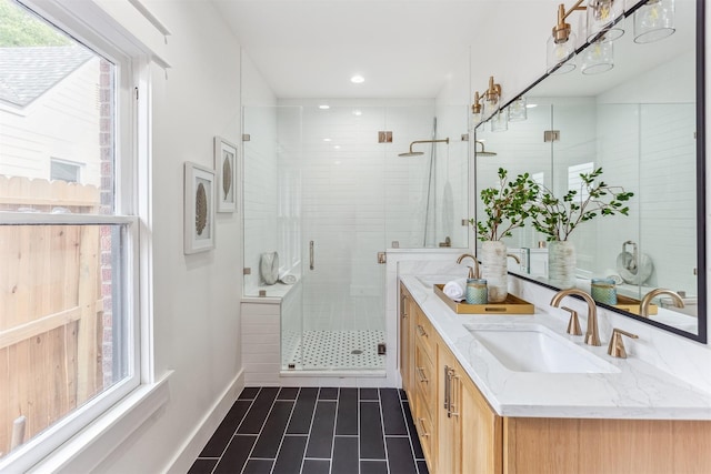 1026 Fugate St, Houston, TX 77009 - full bathroom featuring healthy amount of natural light, a shower stall, double vanity, tile patterned floors, and recessed lighting