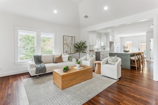 1026 Fugate St, Houston, TX 77009 - living room with dark wood finished floors, baseboards, high vaulted ceiling, and recessed lighting