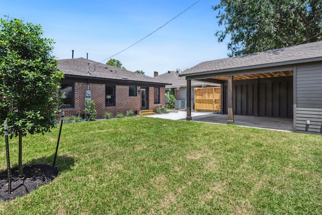 1026 Fugate St, Houston, TX 77009 - view of grassy yard with central AC, a patio area, and entry steps