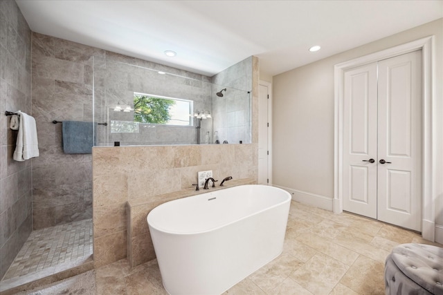 bathroom featuring a walk in shower, recessed lighting, and a soaking tub