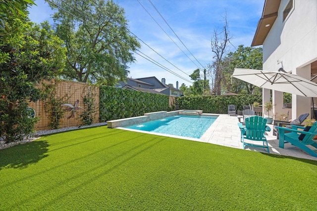 view of swimming pool featuring a yard, a pool with connected hot tub, a fenced backyard, and a patio area