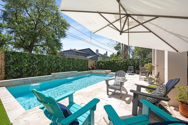 view of pool with a fenced backyard, a patio area, and a pool with connected hot tub