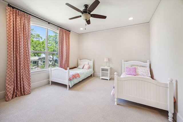 carpeted bedroom with recessed lighting, ceiling fan, ornamental molding, and baseboards