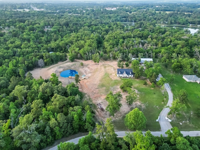 bird's eye view featuring a wooded view