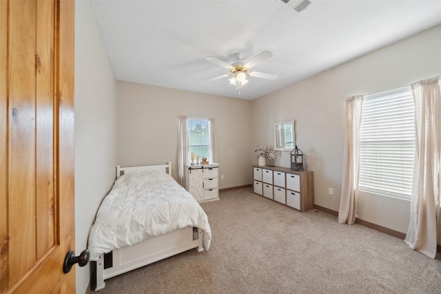 bedroom featuring baseboards, ceiling fan, carpet flooring, and visible vents