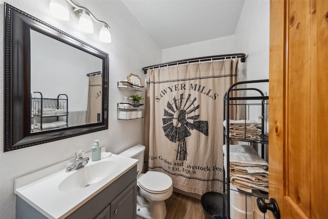full bath featuring vanity, wood finished floors, toilet, and a shower with curtain