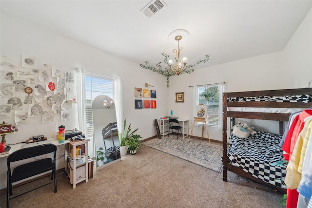 carpeted bedroom featuring baseboards, visible vents, and a chandelier