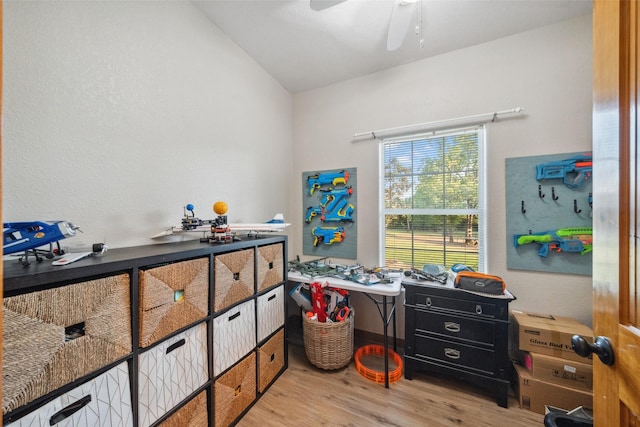 interior space with light wood-style floors, a ceiling fan, and lofted ceiling