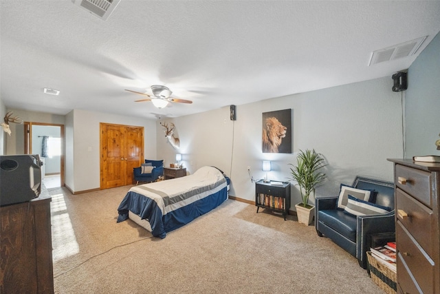 carpeted bedroom featuring baseboards, ceiling fan, and visible vents