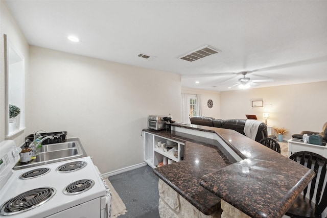 kitchen featuring visible vents, a sink, baseboards, open floor plan, and electric stove