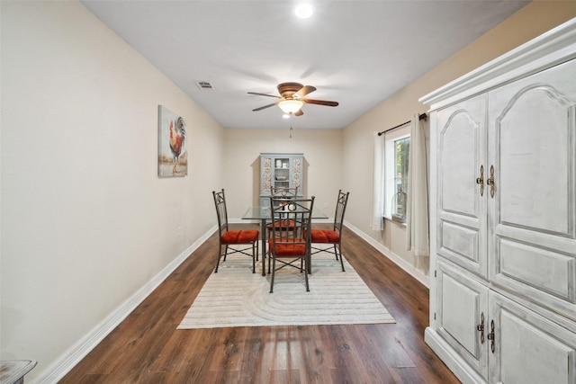 dining area with baseboards, ceiling fan, dark wood finished floors, and visible vents