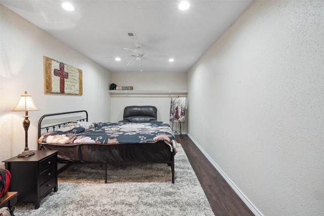 bedroom with ceiling fan, visible vents, wood finished floors, baseboards, and recessed lighting