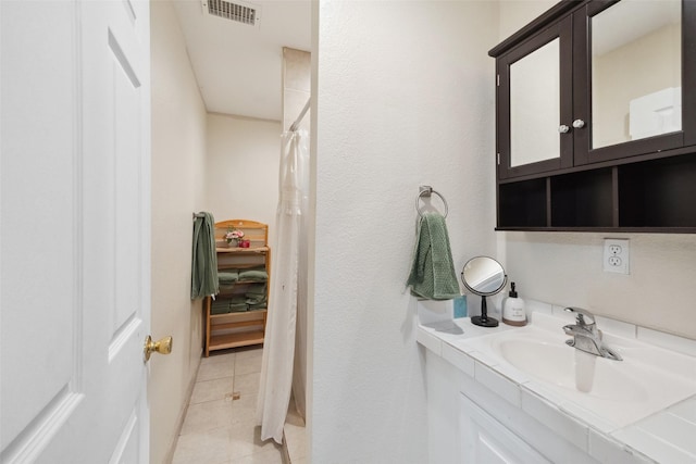 bathroom with a shower with curtain, tile patterned floors, vanity, and visible vents
