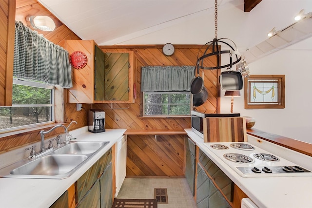 kitchen with a sink, light countertops, vaulted ceiling, and white cooktop
