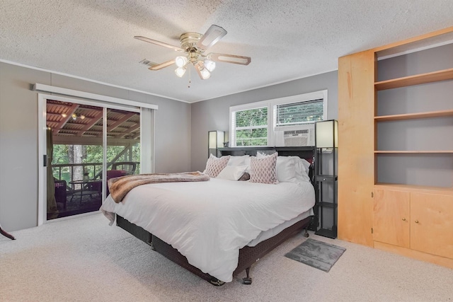 bedroom with carpet, cooling unit, a textured ceiling, and access to exterior