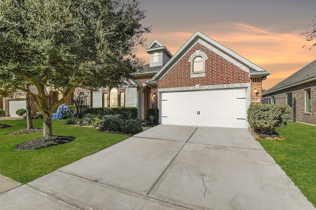 9135 Monarch Field Ln, Cypress, TX 77433 - traditional home featuring brick siding, a garage, a front lawn, and concrete driveway