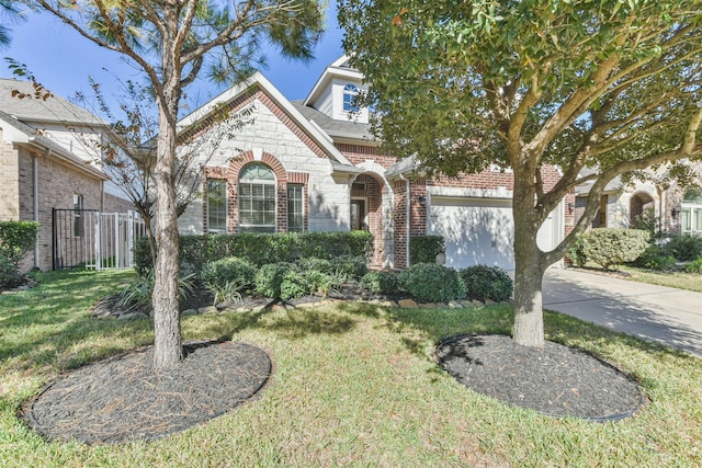 9135 Monarch Field Ln, Cypress, TX 77433 - view of front of property with a front lawn, fence, stone siding, brick siding, and driveway