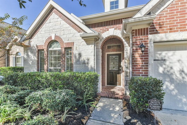 9135 Monarch Field Ln, Cypress, TX 77433 - doorway to property with a garage, stone siding, and brick siding