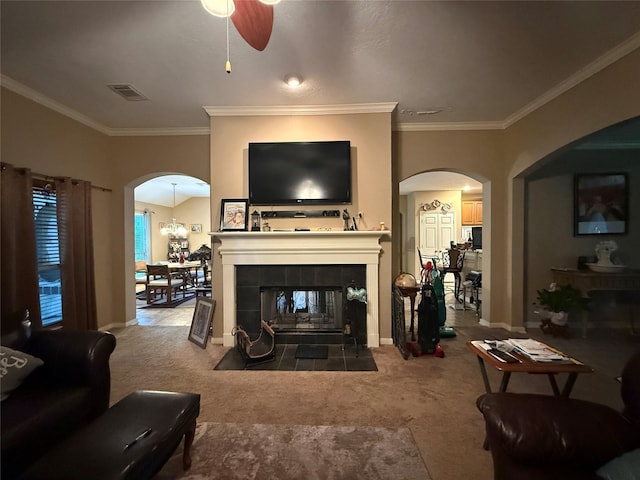 8813 Lauren Ln, Waller, TX 77484 - carpeted living room featuring crown molding, ceiling fan, arched walkways, baseboards, and visible vents