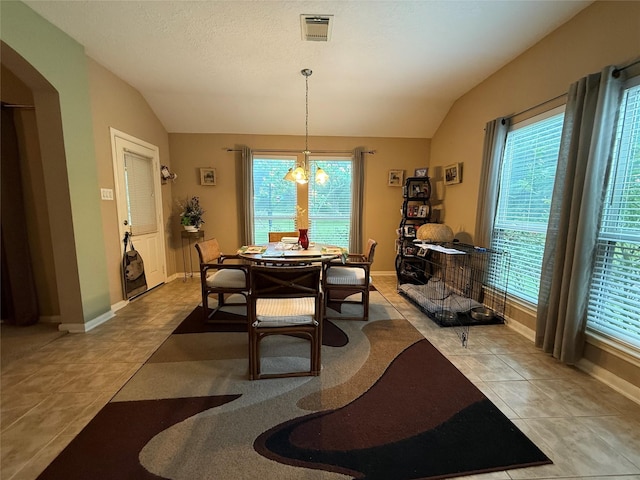 8813 Lauren Ln, Waller, TX 77484 - tiled dining room featuring visible vents, baseboards, lofted ceiling, and a notable chandelier