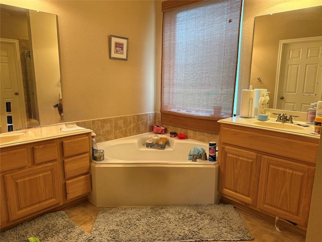 8813 Lauren Ln, Waller, TX 77484 - full bath featuring a sink, tile patterned flooring, a bath, and two vanities