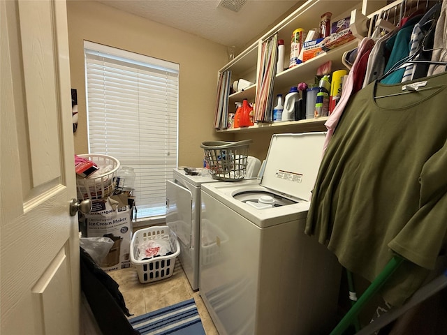 8813 Lauren Ln, Waller, TX 77484 - clothes washing area with separate washer and dryer, laundry area, visible vents, and a textured ceiling