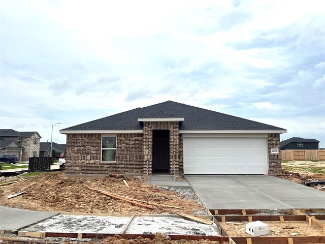 6003 Orange Shr, Katy, TX 77493 - view of front facade featuring brick siding, an attached garage, roof with shingles, and concrete driveway