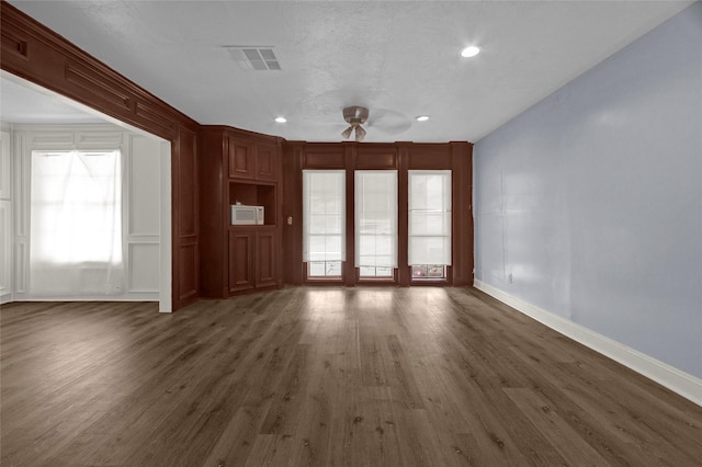 331 Terminal St, Houston, TX 77020 - unfurnished living room featuring plenty of natural light, a ceiling fan, dark wood-style flooring, visible vents, and baseboards