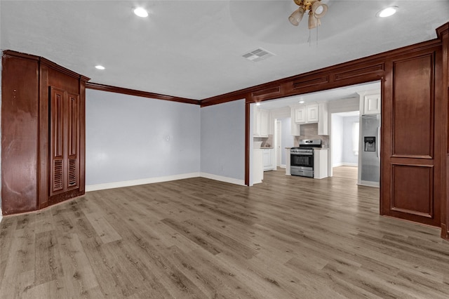 331 Terminal St, Houston, TX 77020 - unfurnished living room with light wood finished floors, a ceiling fan, baseboards, visible vents, and ornamental molding